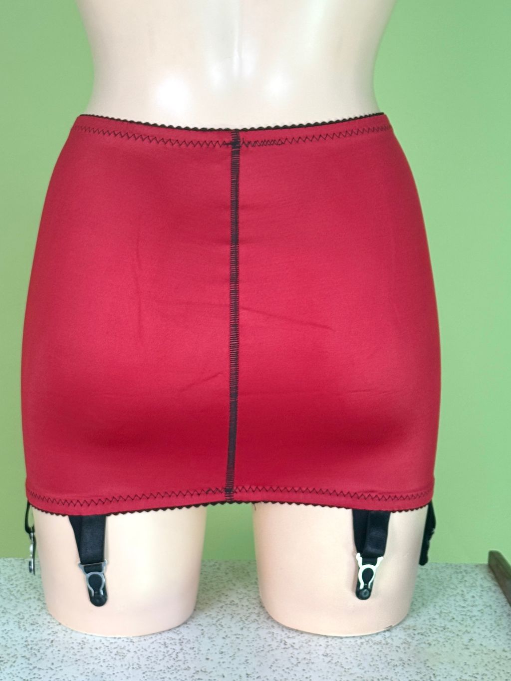 back view of a red girdle on a green background