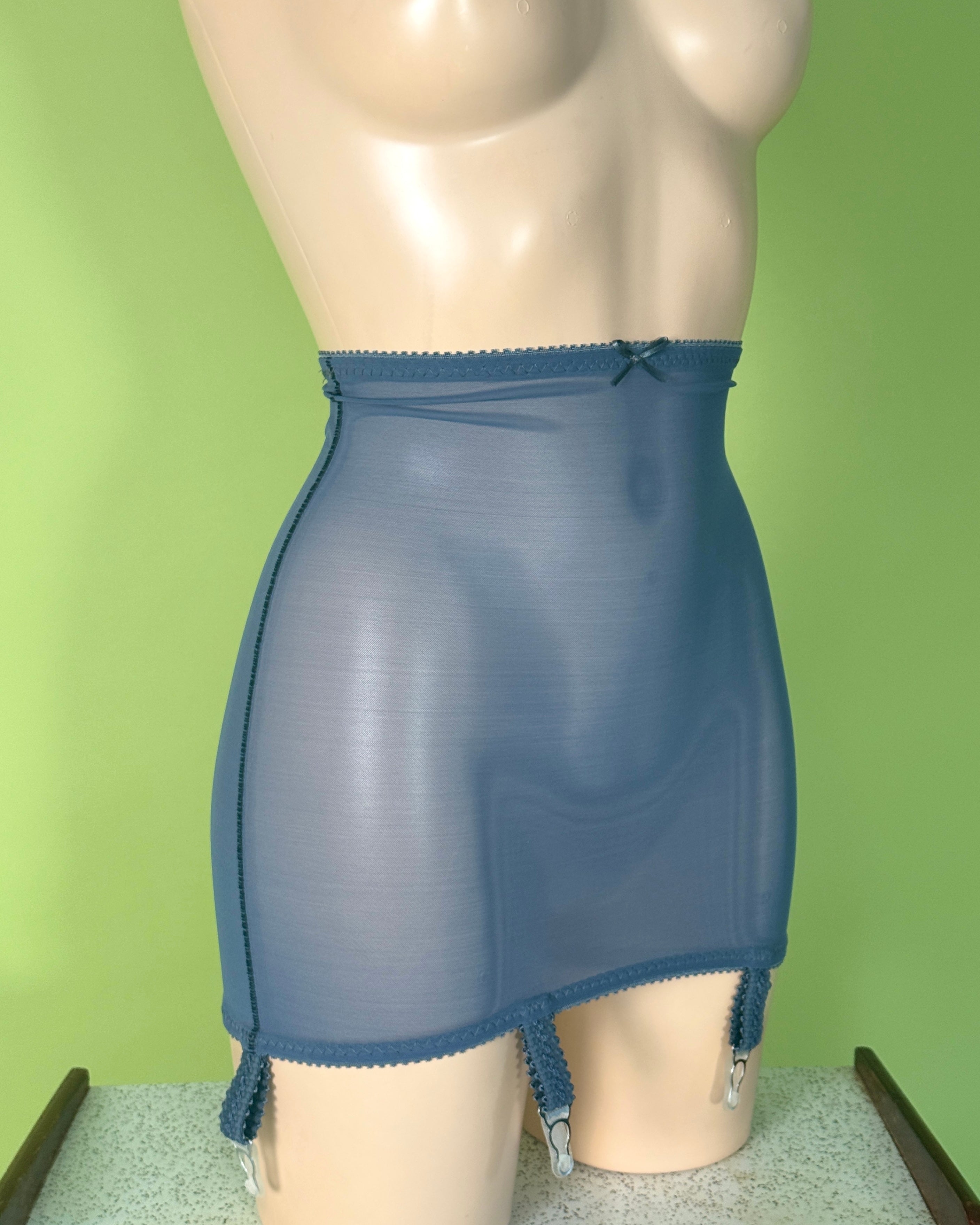 A blue sheer girdle  displayed on a beige mannequin torso against a light green background.