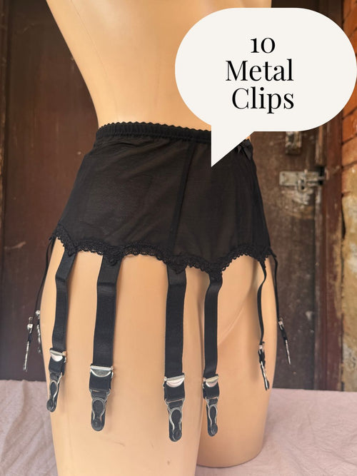 Black  garter belt with lace trim and 10 adjustable straps attached to metal clips, displayed on a beige mannequin torso. A speech bubble overlay reads '10 Metal Clips'.