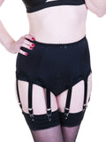 Person wearing black 8 strap suspender belt with stockings on a white background