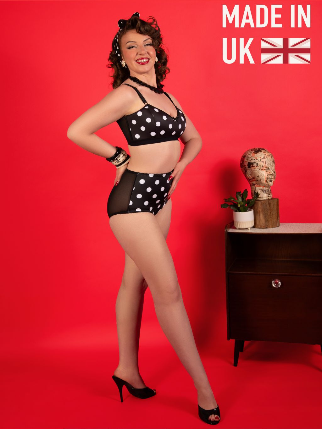 Woman in black and white polka dot lingerie posing against a red background with 'Made in UK' text.