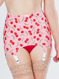 Pink girdle with cherry pattern worn by a person, with lace stockings visible.