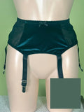 green sheer mesh and velvet garter belt with attached garter straps, displayed on a beige mannequin torso against a light green background.