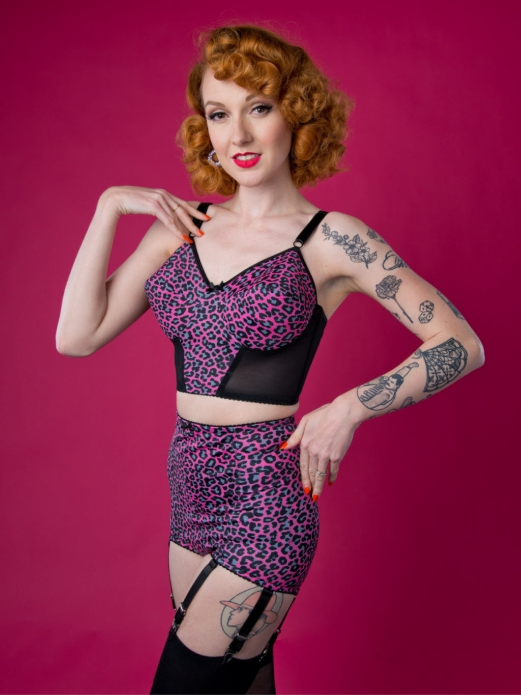Woman wearing a leopard print outfit with a pink background