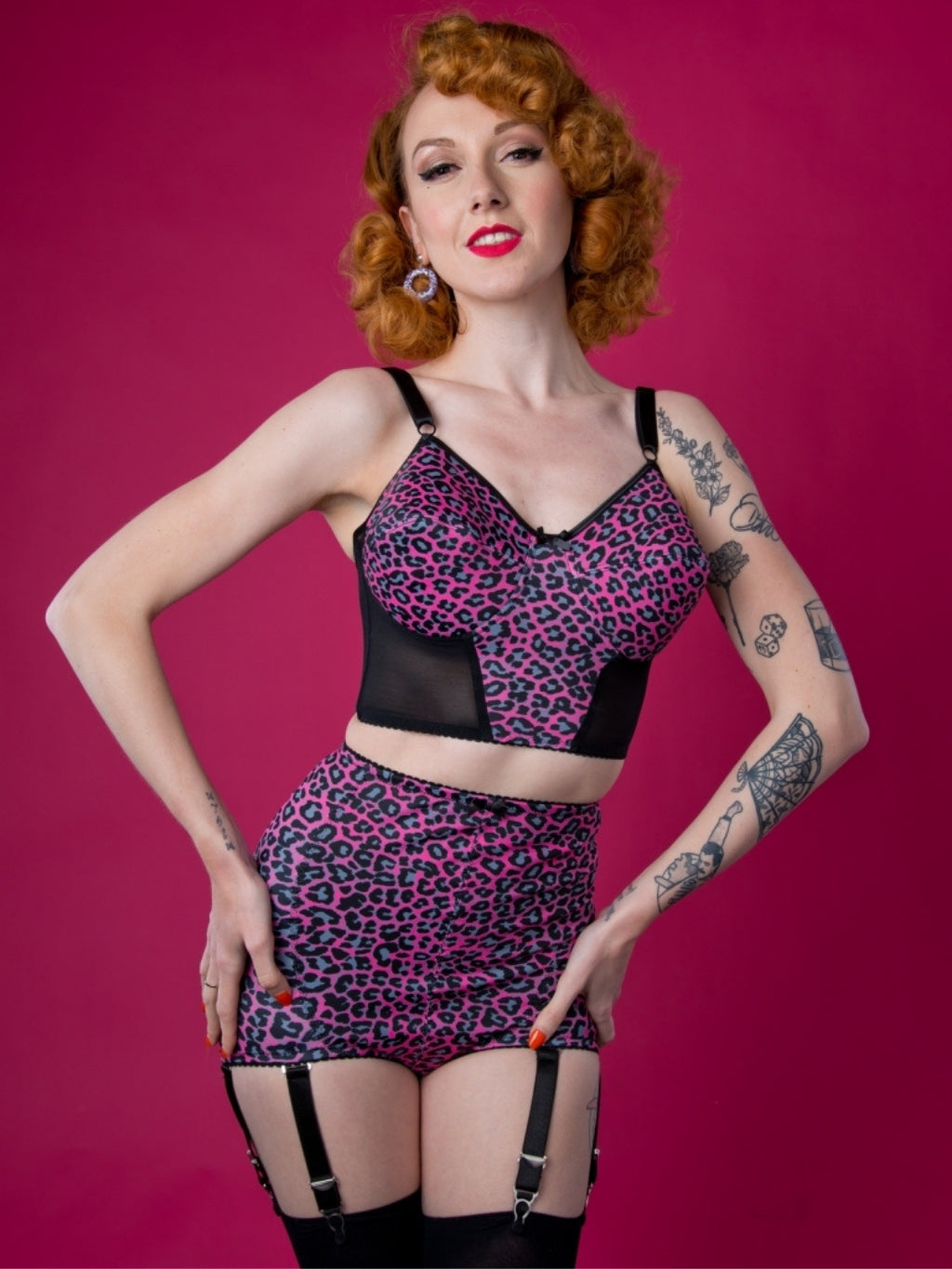 Woman wearing a leopard print lingerie set against a pink background