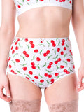 High-waisted underwear with cherry pattern worn by a person on a white background