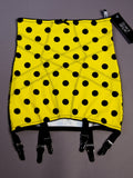 Yellow girdle with black polka dots and straps on a gray background
