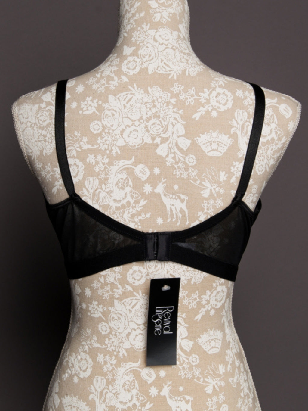 Black bra on a mannequin with a lace background